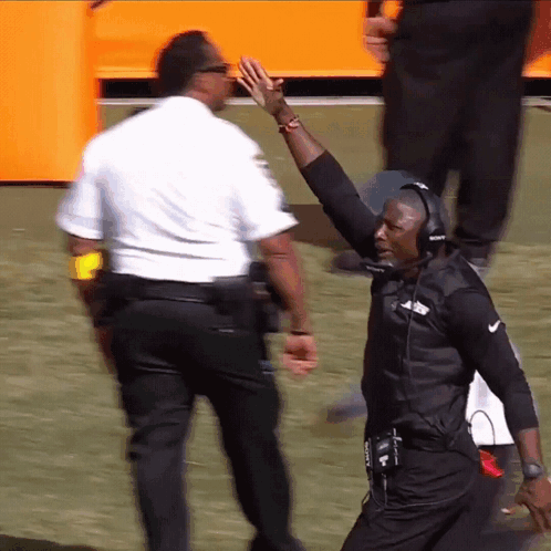 Man With Headphones High-Fiving Police Officer GIF