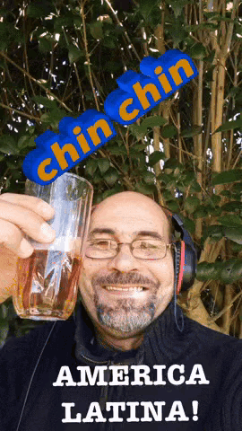 Man With Headphones Holding Glass Saying Chin Chin