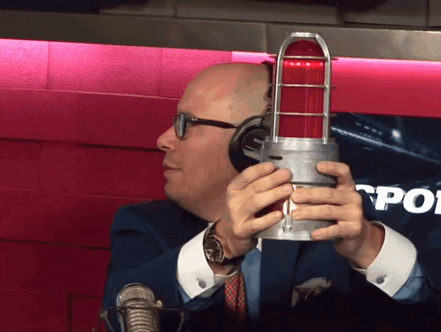 Man with Headphones Holding Red Light