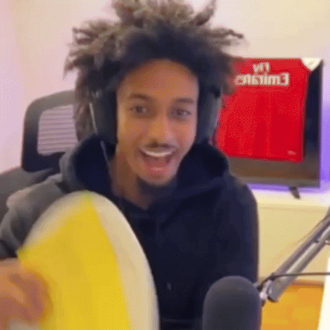 Man With Headphones Holding Yellow Frisbee At Microphone GIF