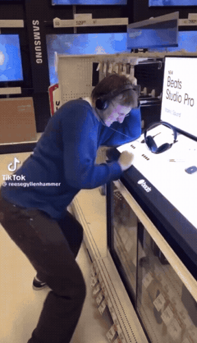 Man With Headphones In Front Of Beats Studio Pro Display GIF