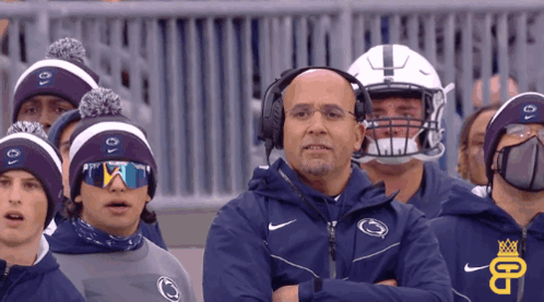 Man With Headphones in Front of Penn State Hats