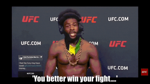 Man With Headphones in Front of UFC Sign