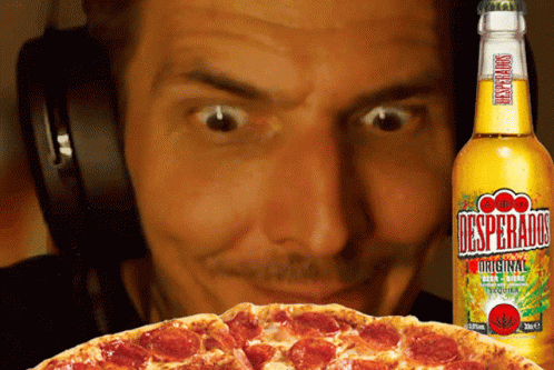 Man With Headphones Looking at Pizza and Desperados