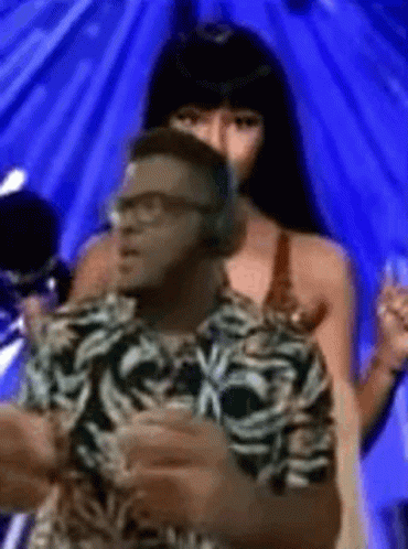 Man With Headphones Next To Woman In Bikini GIF