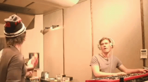 Man With Headphones Playing Keyboard at Mirror