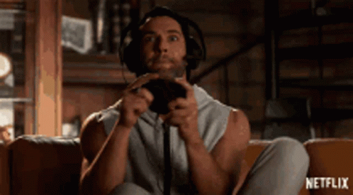 Man With Headphones Playing Video Game On Couch GIF