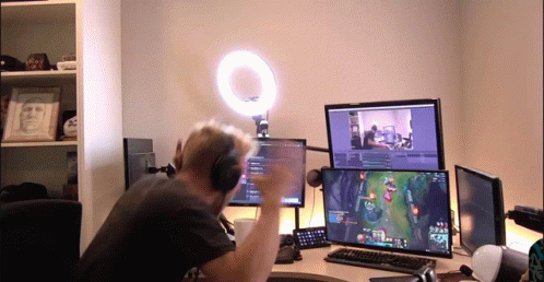Man With Headphones Playing Video Game On Two Monitors GIF