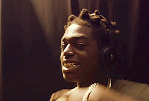 Man With Headphones Pointing at Teeth