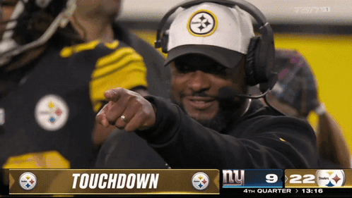 Man With Headphones Pointing at Touchdown Screen