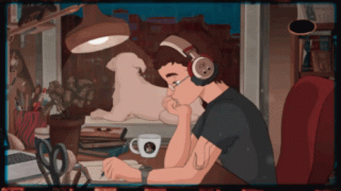 Man With Headphones Sitting at Desk