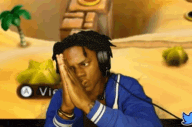 Man With Headphones Sitting at Video Game Hands on Face