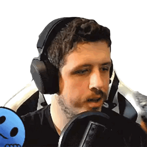 Man with Headphones Sitting by Microphone
