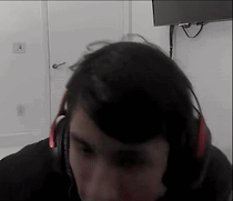 Man With Headphones Sitting in Front of TV