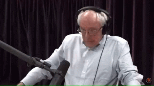 Man With Headphones Talking Into Microphone