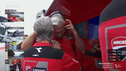 Man With Headphones Talking to Man in Ducati Shirt