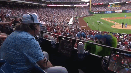 Man With Headphones Watching Baseball Game In Stadium GIF