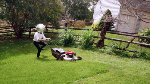 Man With Helmet Mowing Grass GIF