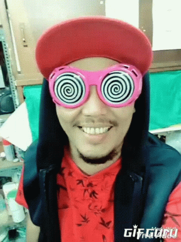 Man with Hypnotic Glasses and Red Hat Smiling