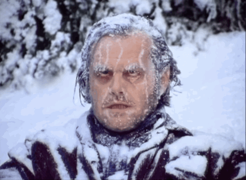 Man With Ice on Face in Snowy Field