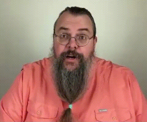 Man With Long Beard and Glasses in Pink Shirt