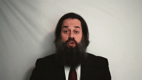 Man With Long Beard In Black Suit And Red Tie GIF