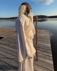 Man With Long Beard Standing on Wooden Dock