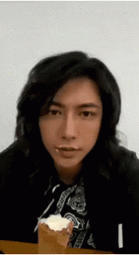Man With Long Black Hair Eating Cake GIF