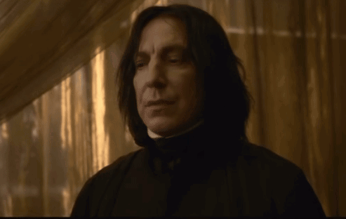 Man with Long Black Hair in Dark Hallway