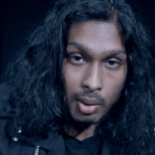 Man With Long Black Hair Making a Face