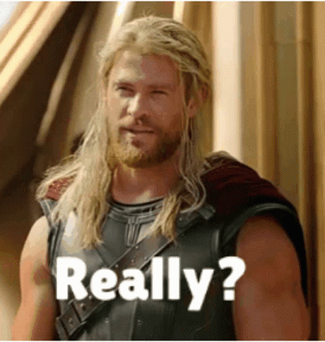 Man With Long Blonde Hair and Beard by Building