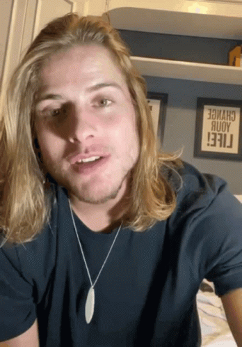 Man With Long Blonde Hair in Black T-Shirt