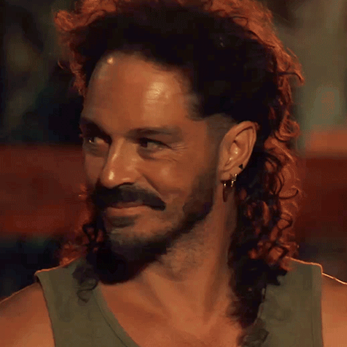 Man with Long Curly Hair and Beard Smiling