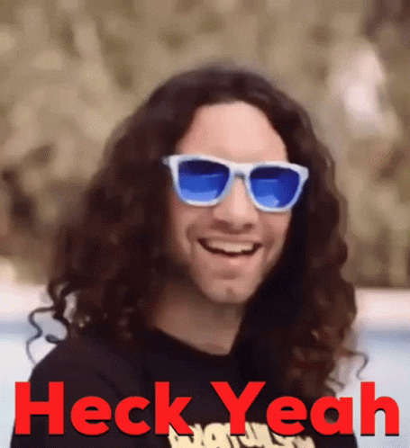 Man With Long Curly Hair and Sunglasses Saying Heck Yeah