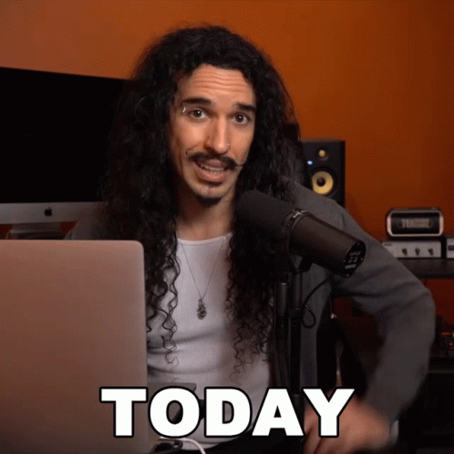 Man With Long Curly Hair At Microphone GIF