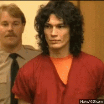 Man With Long Curly Hair In Red Robe And Orange Shirt GIF