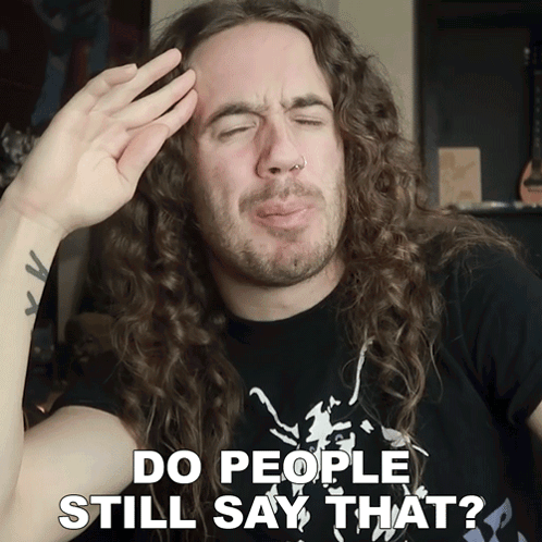 Man with Long Curly Hair Making Funny Face Saying Do People Still Say That
