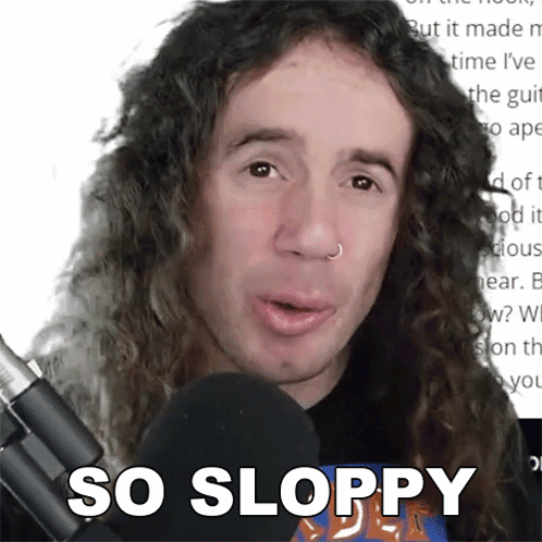 Man With Long Curly Hair Talking Into Microphone With So Sloppy