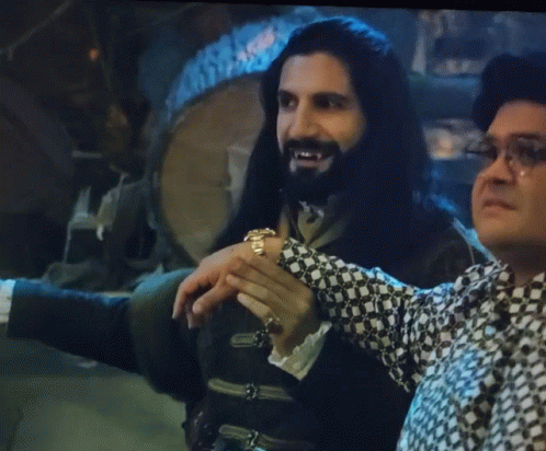 Man With Long Hair and Beard Beside Another Man