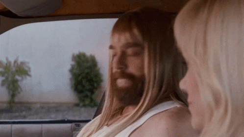 Man With Long Hair and Beard Beside Woman