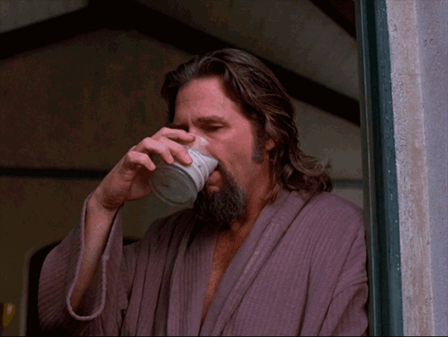 Man with Long Hair and Beard Drinking Milk