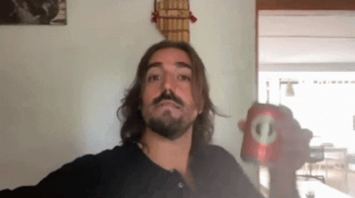 Man with Long Hair and Beard Holding Soda Can with Circle