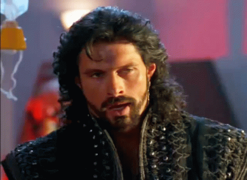 Man With Long Hair and Beard in Black Jacket With Studs