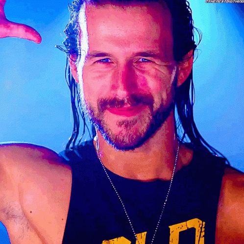 Man With Long Hair and Beard in Black Tank Top With Letter D