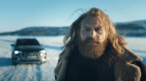 Man With Long Hair And Beard In Front Of Car GIF
