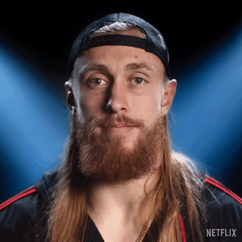 Man With Long Hair and Beard in Netflix Hat and Shirt