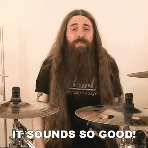Man with Long Hair and Beard in Pearl Shirt Playing Drums