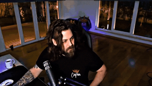 Man With Long Hair and Beard in Shirt Saying Calm