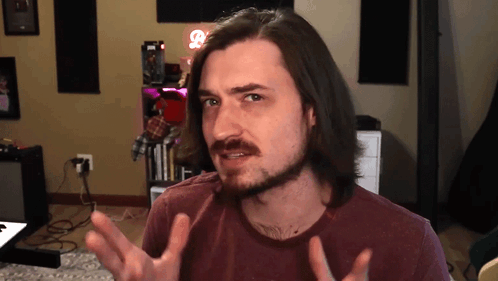 Man With Long Hair and Beard Making Face