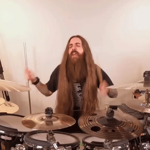 Man With Long Hair And Beard Playing Drum Set GIF